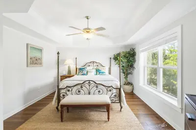 a bedroom with a bed and a ceiling fan at Sandy Shenanigans by Blu Skye! -New to Management 2025! in Panama City Beach