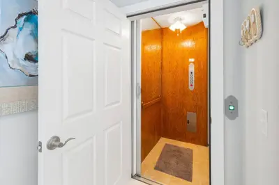 a white door with a mirror in a bathroom at Sandy Shenanigans by Blu Skye! -New to Management 2025! in Panama City Beach