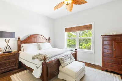 a bedroom with a bed and a dresser and a window at Sandy Shenanigans by Blu Skye! -New to Management 2025! in Panama City Beach
