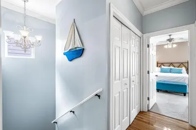 a hallway with a door leading to a bedroom at Beach Bummin' - Week long stays get 4 free bikes rental! in Rosemary Beach
