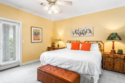 a bedroom with a bed and a ceiling fan at Beach Bummin' - Week long stays get 4 free bikes rental! in Rosemary Beach
