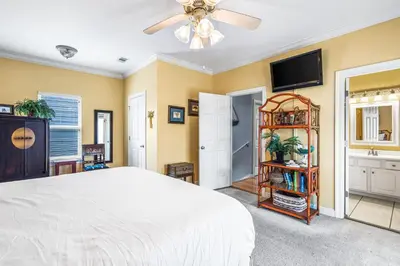 a bedroom with a bed and a ceiling fan at Beach Bummin' - Week long stays get 4 free bikes rental! in Rosemary Beach