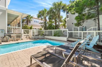 a swimming pool with two lounge chairs next to a house at Amaryllis Point - 30A, Private Pool, Bicycles, 3 King Masters! in Rosemary Beach