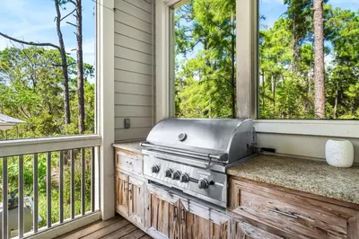 a kitchen with a stove and two windows at Amaryllis Point - 30A, Private Pool, Bicycles, 3 King Masters! in Rosemary Beach