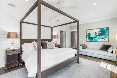 a bedroom with a canopy bed and a couch at Amaryllis Point - 30A, Private Pool, Bicycles, 3 King Masters! in Rosemary Beach