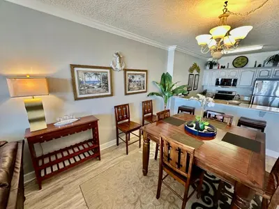 a kitchen and dining room with a table and chairs at Ocean Reef 1607 in Panama City Beach