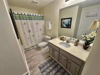 a bathroom with a sink and a toilet and a shower at Ocean Reef 1607 in Panama City Beach