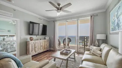 a living room with a couch and a ceiling fan at Tropic Winds 2101 in Panama City Beach