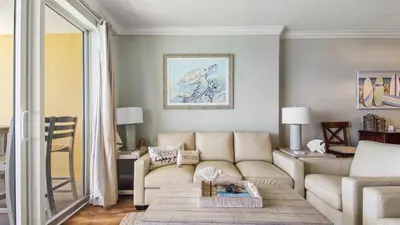 a living room with a couch and a table at Tropic Winds 2101 in Panama City Beach