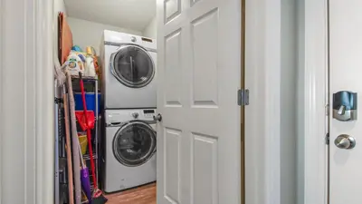 a laundry room with a washer and dryer next to a door at Tropic Winds 2101 in Panama City Beach