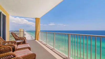 a balcony with chairs and a view of the ocean at Tropic Winds 2101 in Panama City Beach