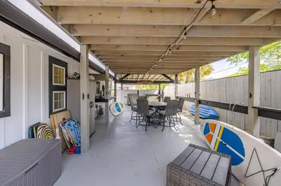 a covered patio with a table and chairs at Bayview Cottage - Sun deck, pool, and more! in Panama City Beach