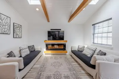 a living room with two couches and a fireplace at Bayview Cottage - Sun deck, pool, and more! in Panama City Beach