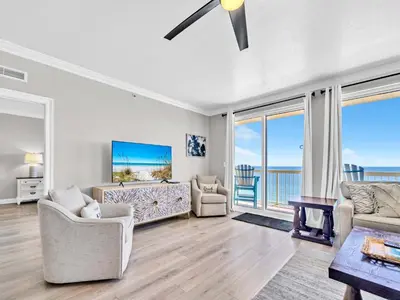 a living room with a view of the ocean at Calypso 1-1709 by Emerald Coast Retreats in Panama City Beach