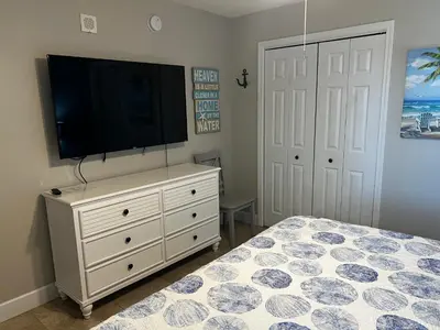 a bedroom with a tv on top of a dresser at Panama City Beach, Beach Front Condo 207 in Panama City Beach