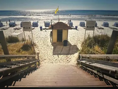 a small building on the beach near the ocean at Panama City Beach, Beach Front Condo 207 in Panama City Beach