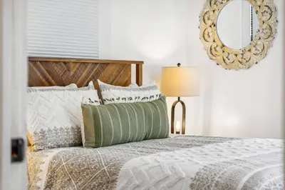 a bedroom with a bed with a mirror on the wall at a block away from beach/Harbor/Fine restaurants in Panama City
