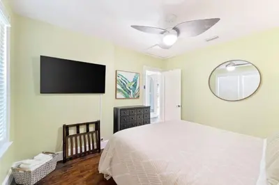 a bedroom with a bed and a flat screen tv at a block away from beach/Harbor/Fine restaurants in Panama City
