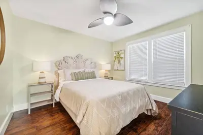 a bedroom with a bed and a ceiling fan at a block away from beach/Harbor/Fine restaurants in Panama City