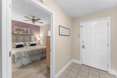a bedroom with a bed and a ceiling fan at Laketown Wharf #236 by Nautical Properties in Panama City Beach