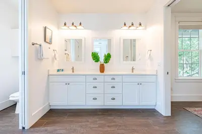 a bathroom with white cabinets and a potted plant at 9 E Willow Mist in Preserve at Inlet Beach in Inlet Beach
