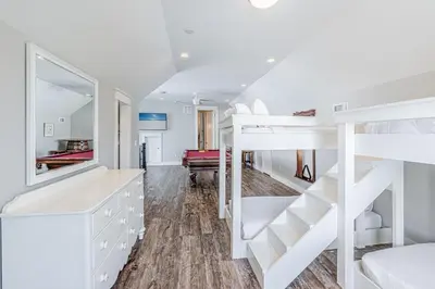 a bedroom with bunk beds and a living room at 9 E Willow Mist in Preserve at Inlet Beach in Inlet Beach