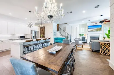 a kitchen and dining room with a wooden table and chairs at 9 E Willow Mist in Preserve at Inlet Beach in Inlet Beach