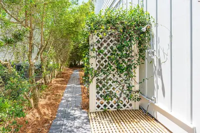 a garden gate with ivy on the side of a house at 9 E Willow Mist in Preserve at Inlet Beach in Inlet Beach