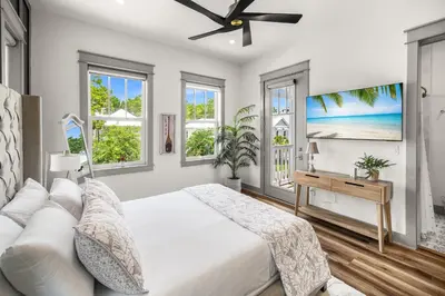 a bedroom with a bed and a ceiling fan at Blue Porch Paradise in Inlet Beach