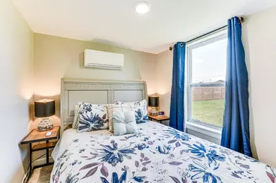 a bedroom with a bed and a window at 13 Mi to St Andrews State Park Cabin with Patio! in Panama City