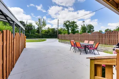 a patio with chairs and a table and a fence at 13 Mi to St Andrews State Park Cabin with Patio! in Panama City