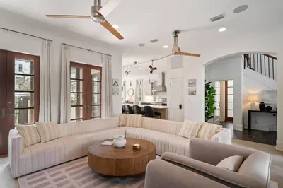 a living room with a couch and a table at Vitamin Sea -Heart of Rosemary Beach. in Rosemary Beach