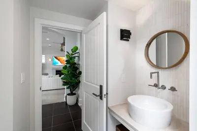 a bathroom with a white sink and a mirror at Vitamin Sea -Heart of Rosemary Beach. in Rosemary Beach