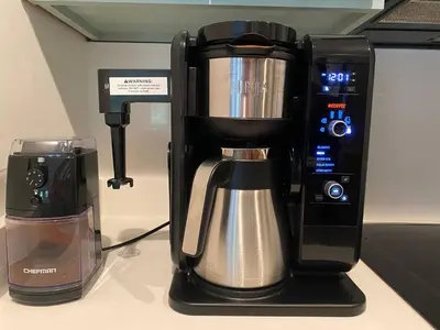 a coffee maker sitting on top of a counter at Vitamin Sea -Heart of Rosemary Beach. in Rosemary Beach