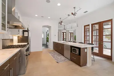 a large kitchen with a stove and a counter top at Vitamin Sea -Heart of Rosemary Beach. in Rosemary Beach