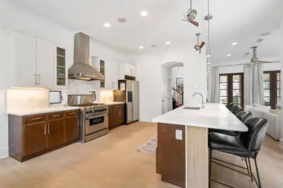a kitchen with a large island in the middle at Vitamin Sea -Heart of Rosemary Beach. in Rosemary Beach
