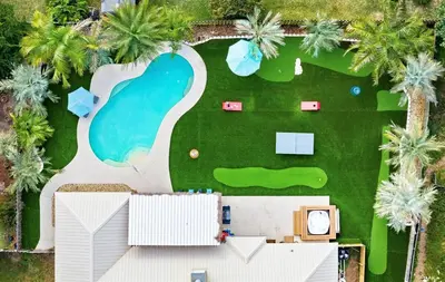 an aerial view of a resort with a pool and palm trees at Caribbean feel,Mini&Disc Golf,Heated Pool,Game Rom in Panama City Beach