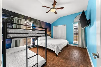 a bedroom with two bunk beds and a ceiling fan at Caribbean feel,Mini&Disc Golf,Heated Pool,Game Rom in Panama City Beach