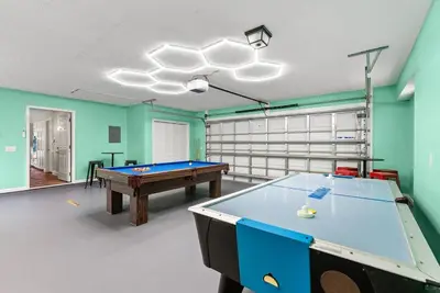 a pool table in a room with green walls at Caribbean feel,Mini&Disc Golf,Heated Pool,Game Rom in Panama City Beach