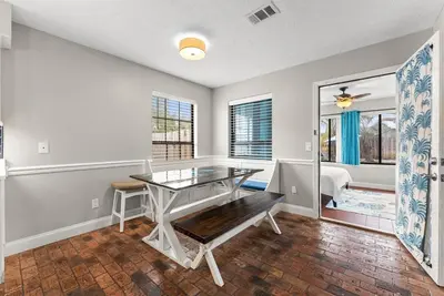 a dining room with a glass table and a bedroom at Caribbean feel,Mini&Disc Golf,Heated Pool,Game Rom in Panama City Beach