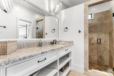 a bathroom with a sink and a shower at 99 Sandy Shores Ct in Inlet Beach