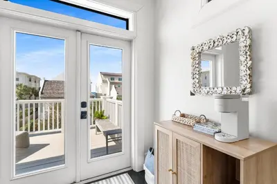 a white room with a door and a mirror at 99 Sandy Shores Ct in Inlet Beach