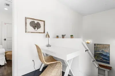 a white desk in a white room with a chair at 99 Sandy Shores Ct in Inlet Beach