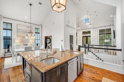 a kitchen with a sink and a counter top at Treetop Cottage in Rosemary Beach