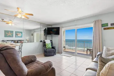 a living room with a view of the ocean at The Summit 1009 in Panama City Beach