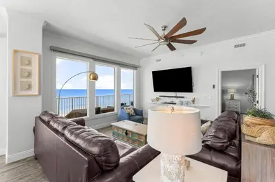 a living room with a couch and a television at Treasure Island #0401 in Panama City Beach