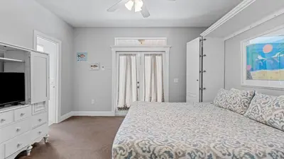 a bedroom with a bed and a flat screen tv at Walk to Santa Rosa Beach Private Pool Balcony and Coastal Views in Santa Rosa Beach