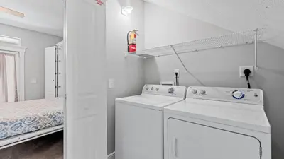a white laundry room with a washer and dryer at Walk to Santa Rosa Beach Private Pool Balcony and Coastal Views in Santa Rosa Beach