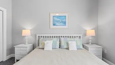 a bedroom with a bed with pillows and two lamps at Walk to Santa Rosa Beach Private Pool Balcony and Coastal Views in Santa Rosa Beach