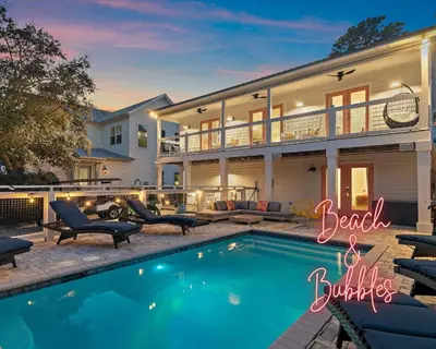 a house with a swimming pool in front of it at Beach & Bubbles in Santa Rosa Beach
